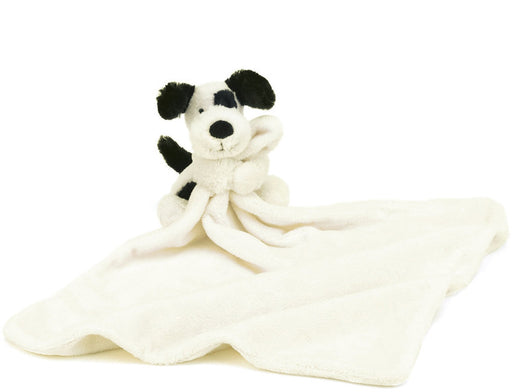 Black and cream spotted Puppy with small Blanket
