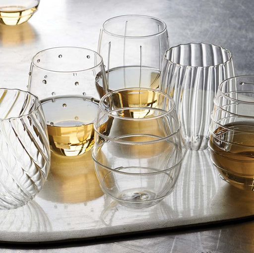 Stemless wine glasses each with a unique tactile design